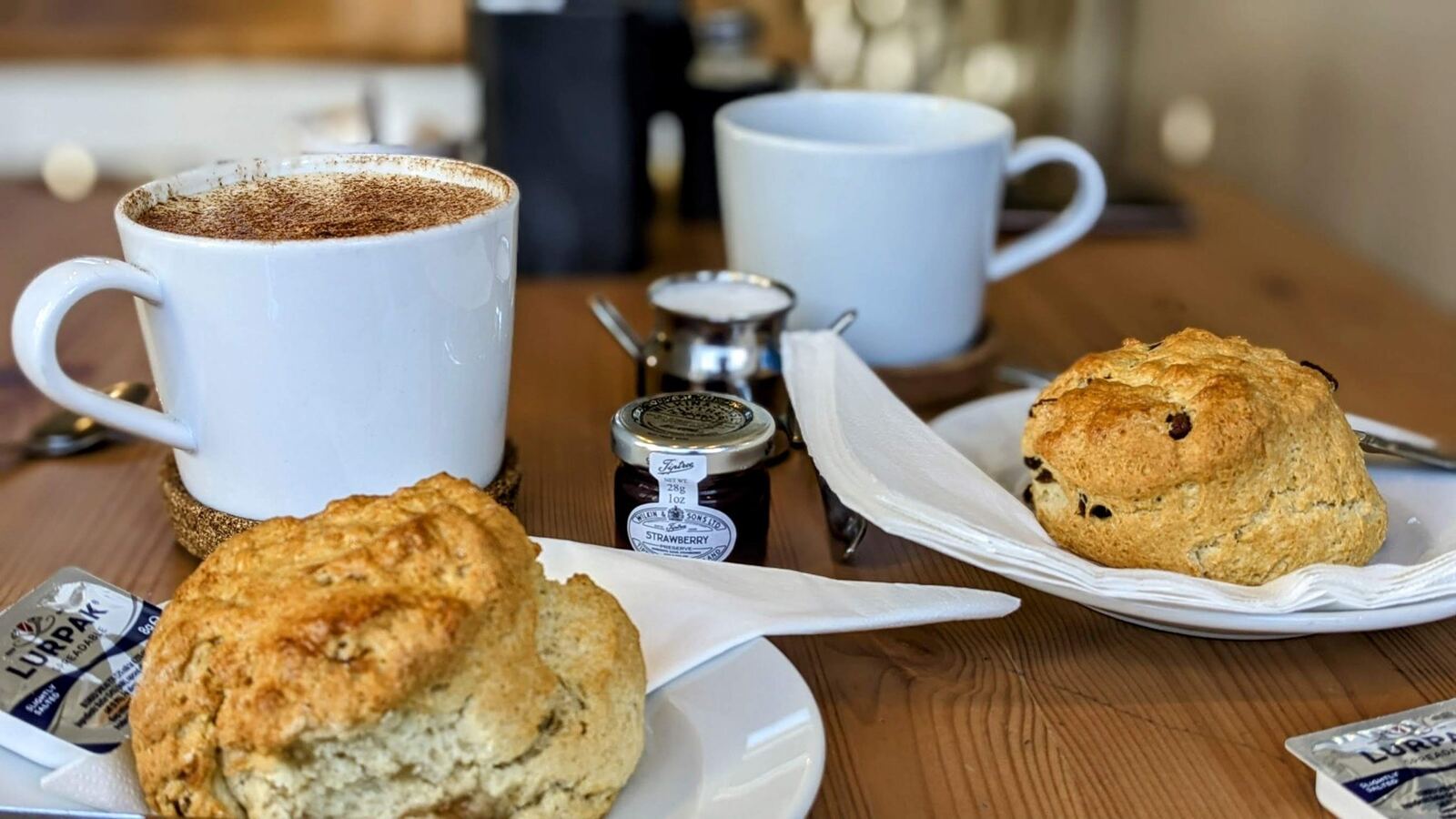 A coffee and a scone on a café table in Aberdour.