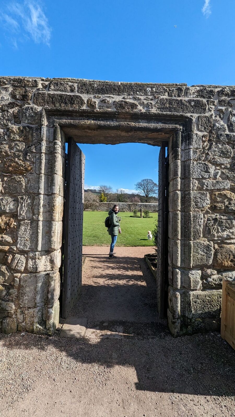 A figure framed in an old stone doorway of Aberdour Castle.