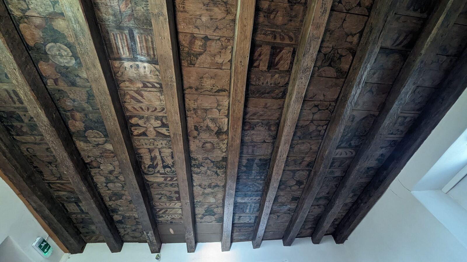 A decorated painted timber ceiling inside Aberdour Castle.
