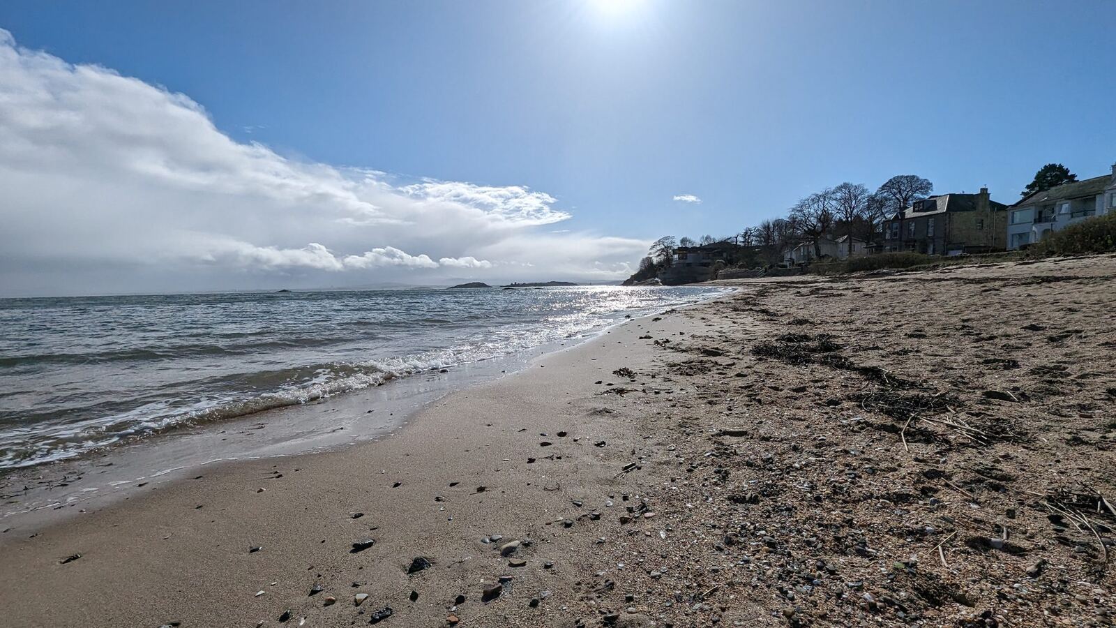 The wide golden Silver Sands beach at Aberdour under a big sky.