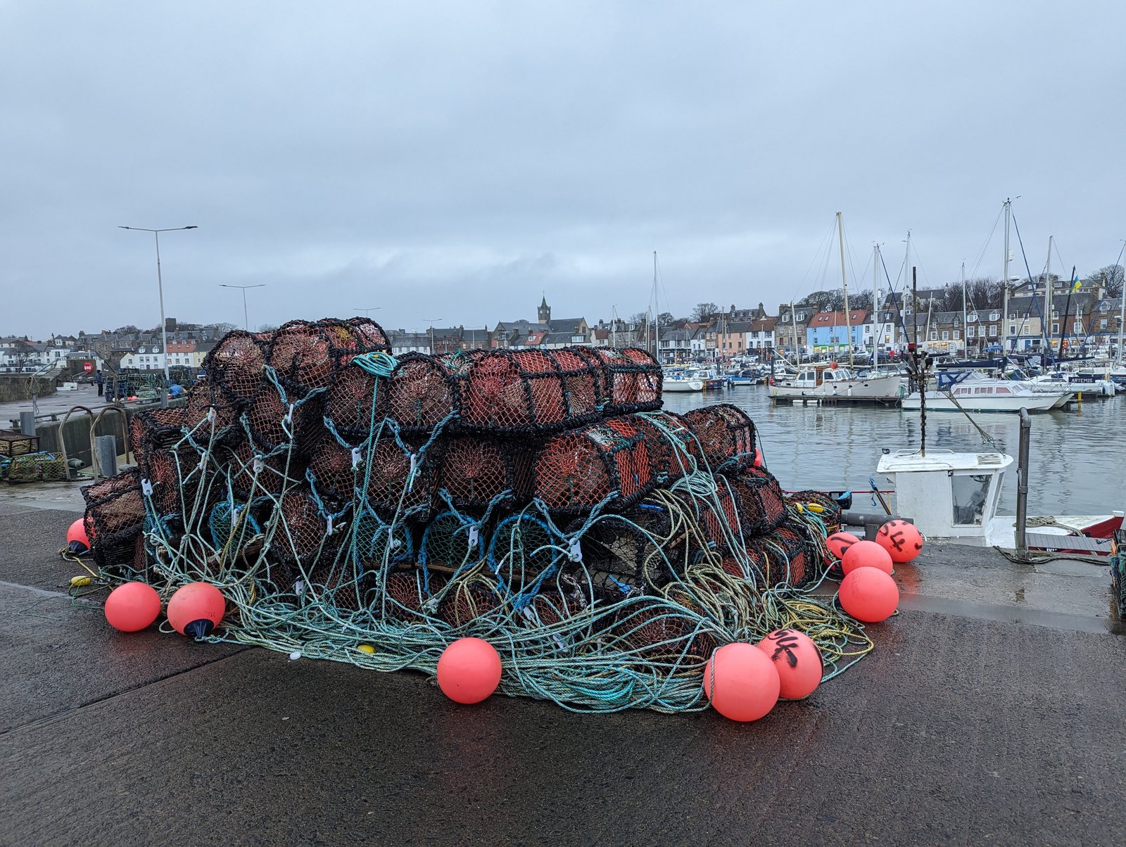 Lobster creels and red buoys on the quay at Anstruther.