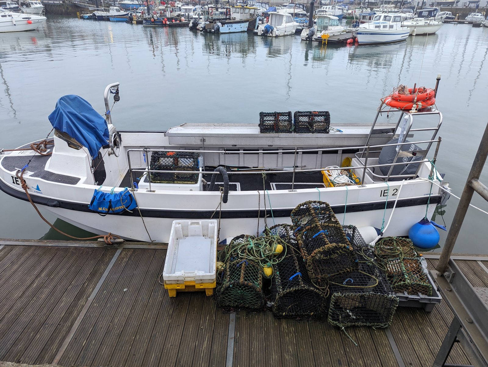 A working fishing boat with creels stacked on deck at Anstruther.