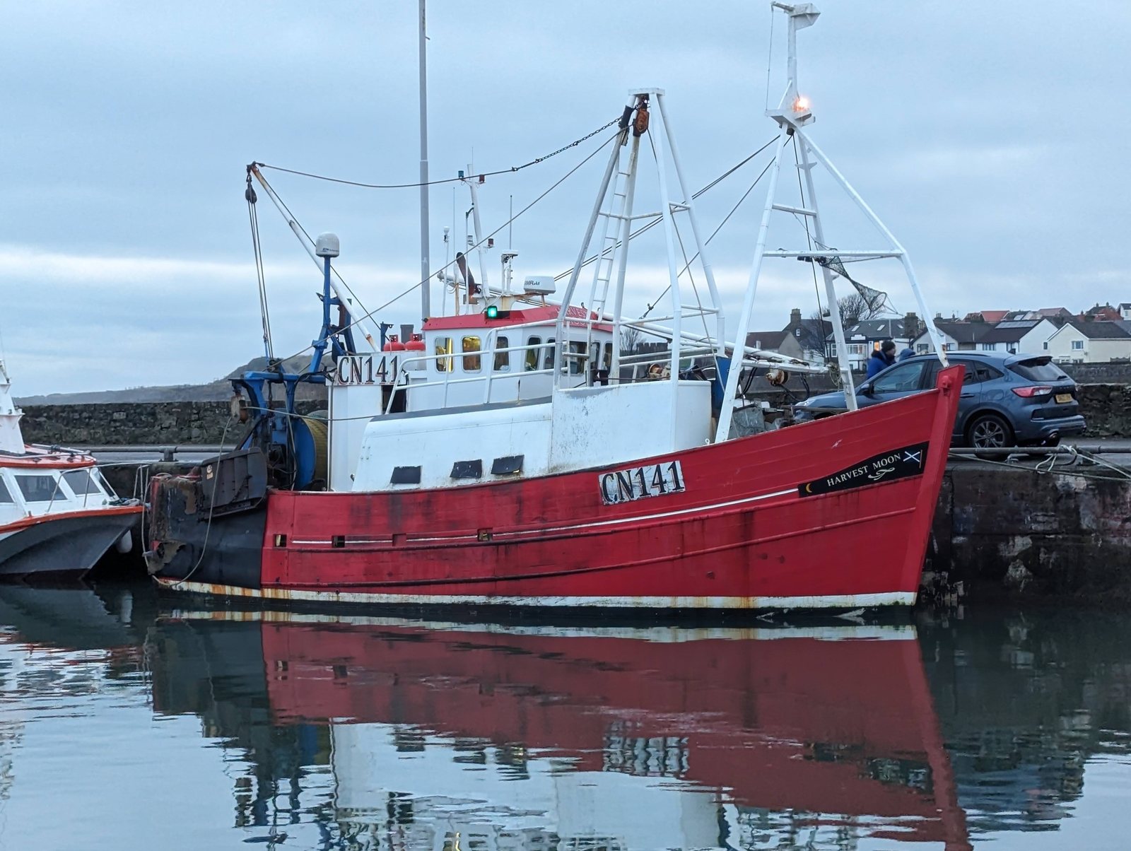A red trawler mirrored in the still water at Anstruther.