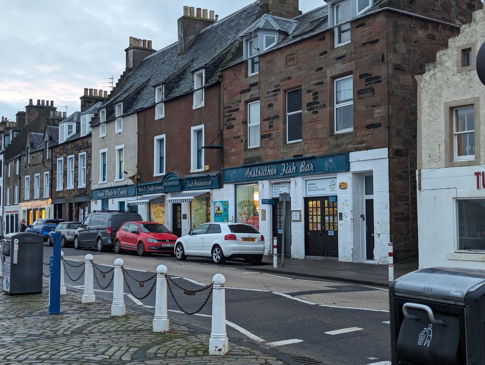 An old street winding up from the shore at Anstruther at dusk.