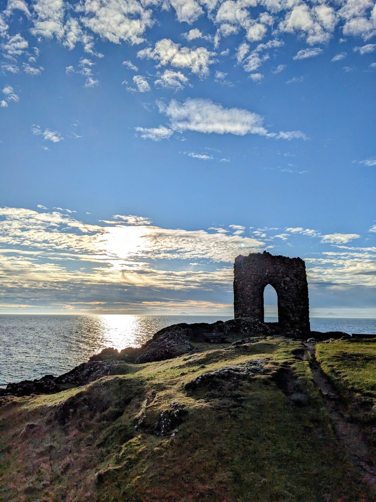 A roofless stone tower on the shore at Anstruther catching the sunrise.