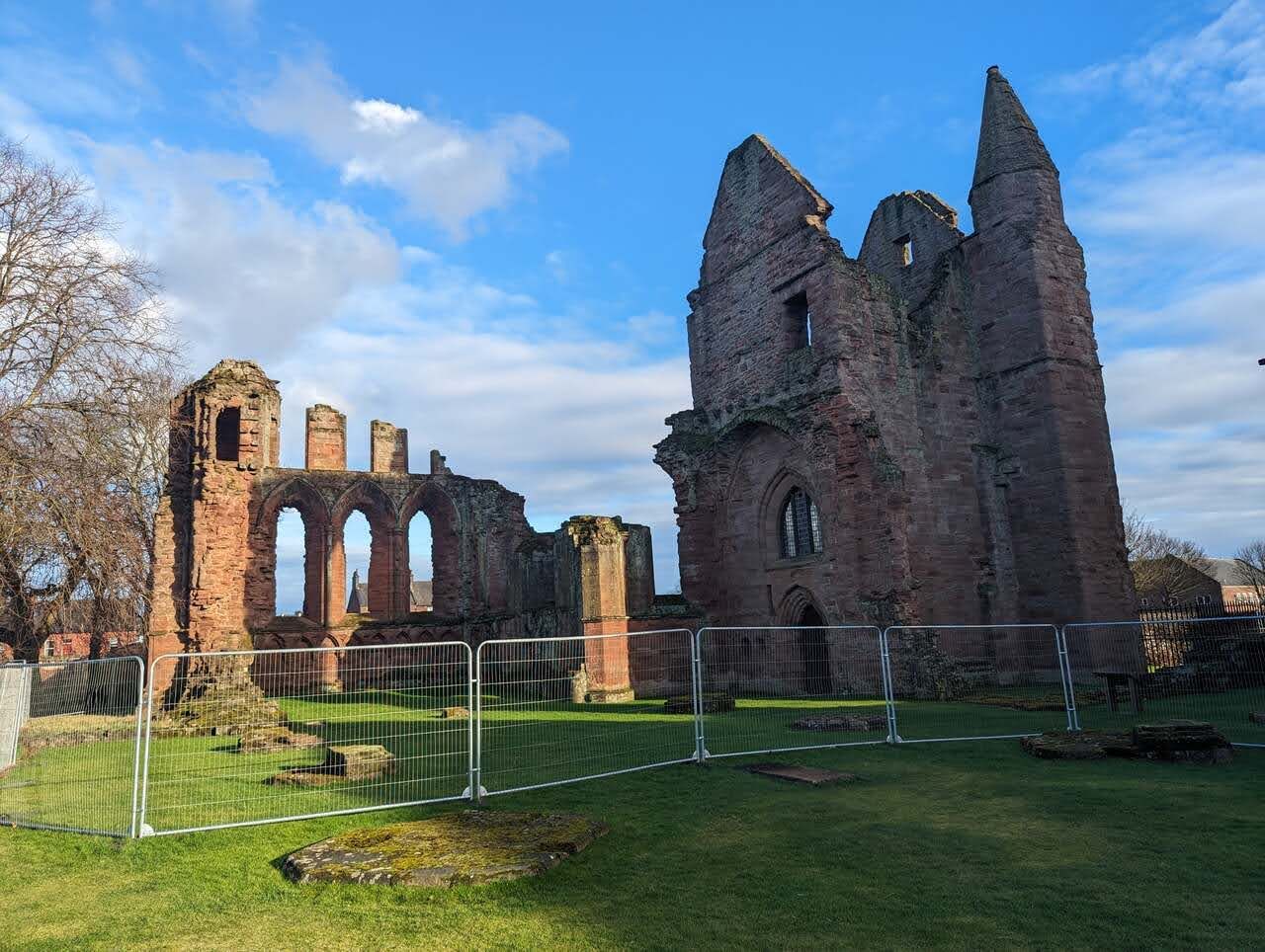 The ruins of Arbroath Abbey across the green.