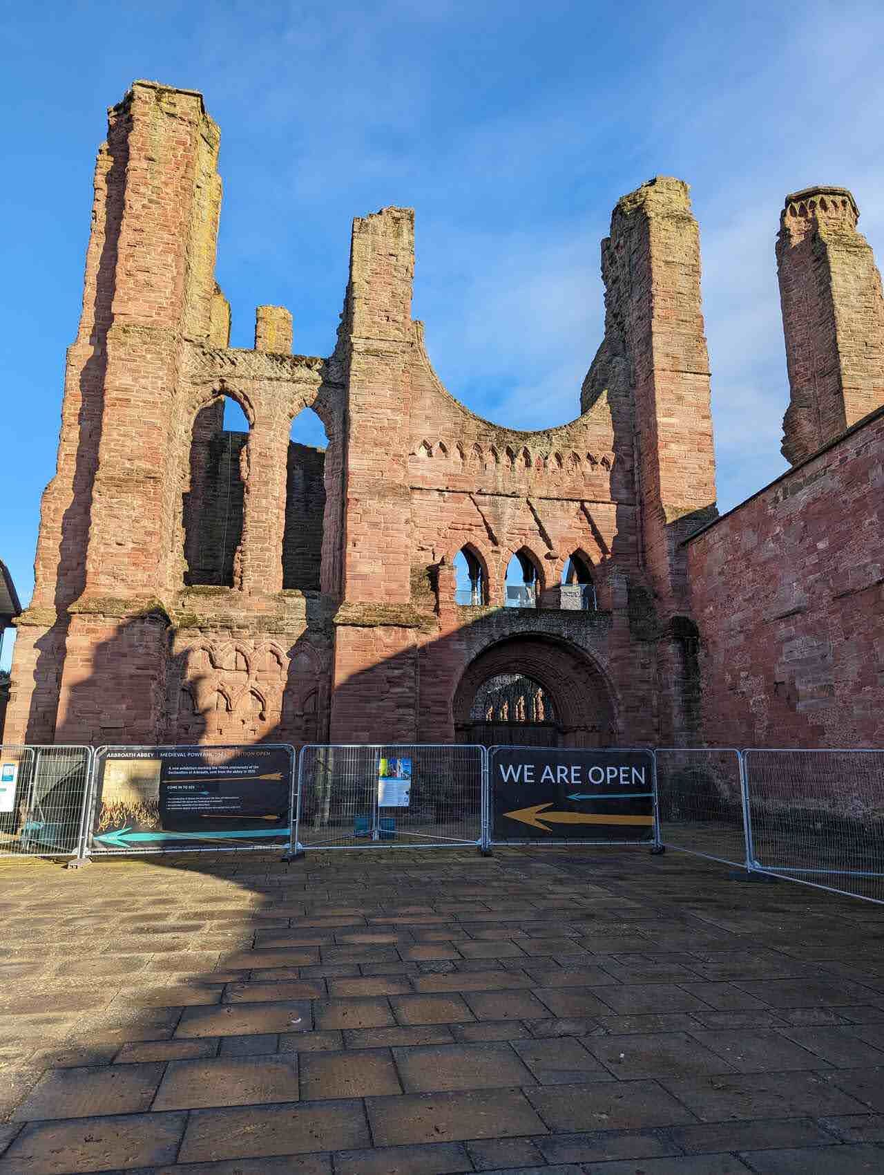 The great red-sandstone west front of Arbroath Abbey.