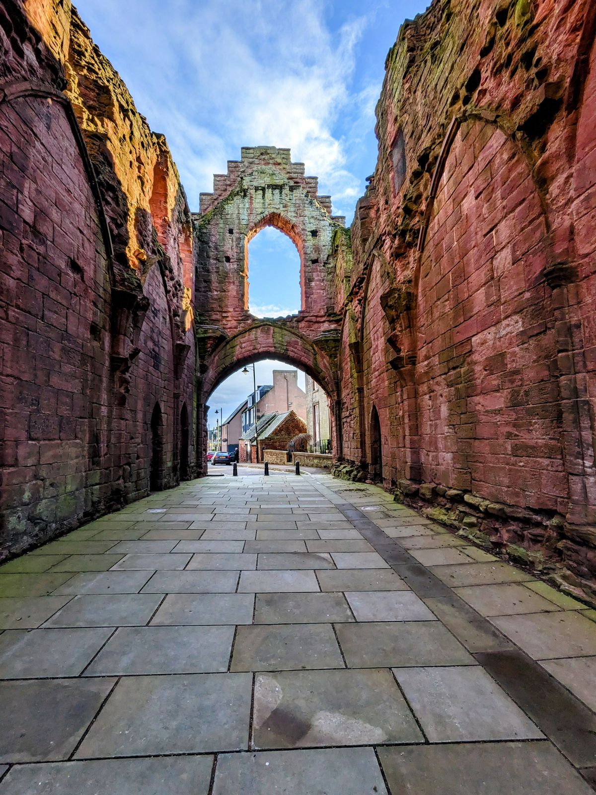 The long paved nave of the ruined Arbroath Abbey church.