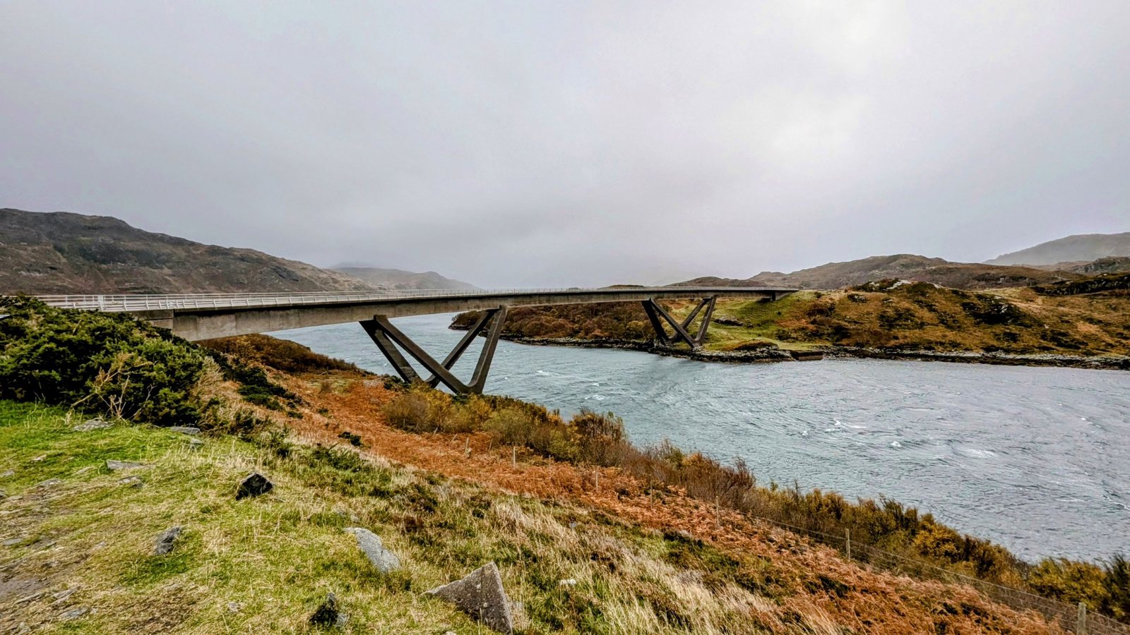 The curved Kylesku Bridge over Loch a'Chairn Bhain.