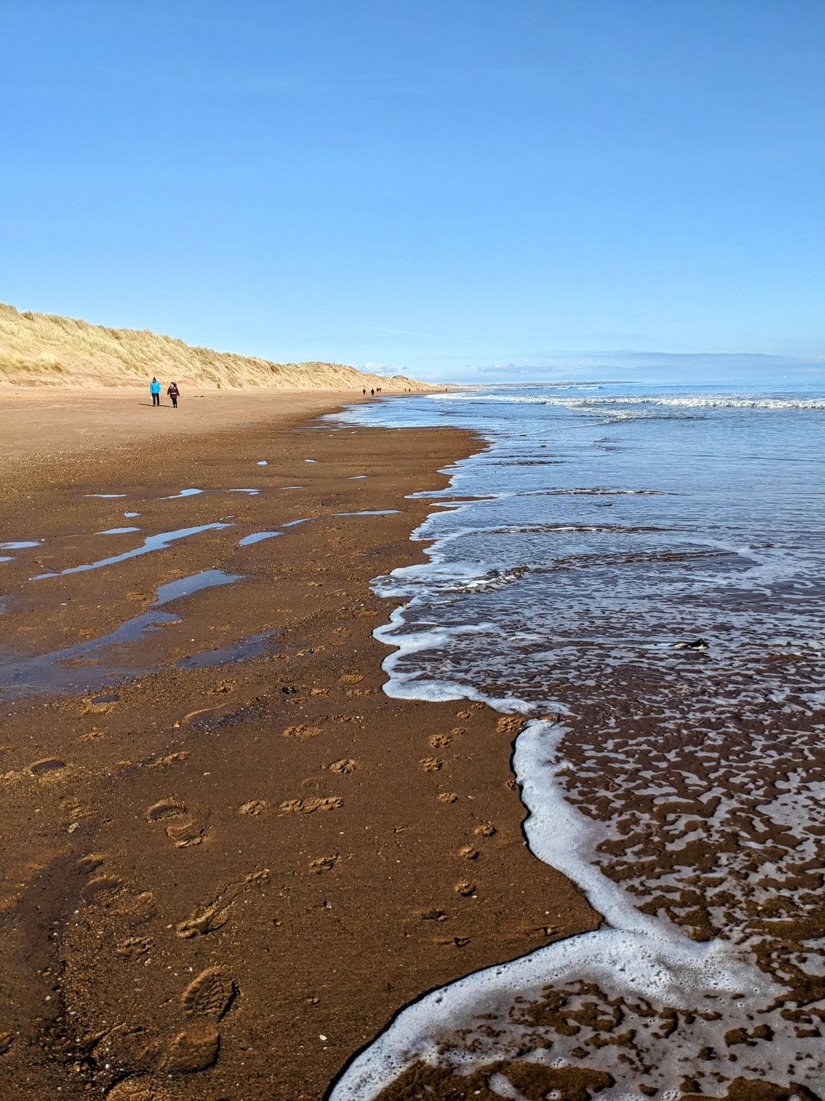 Surf along the long strand at Balmedie.