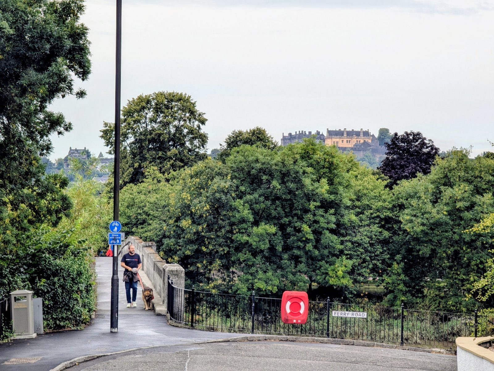 Stirling Castle on its rock seen in the distance from a lane in Cambuskenneth.
