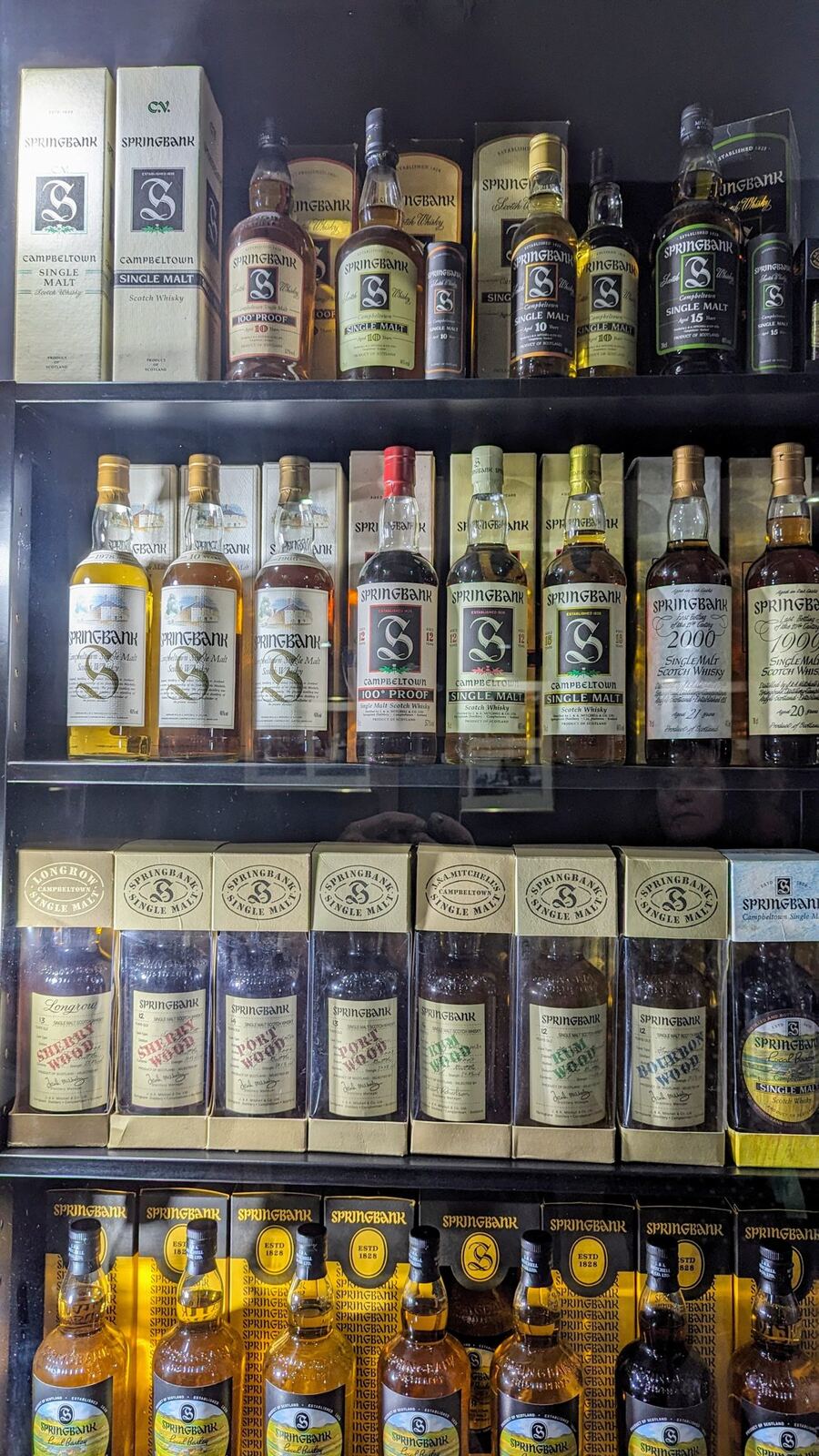 Shelves of Springbank and Cadenhead's whisky bottles in the distillery shop in Campbeltown.