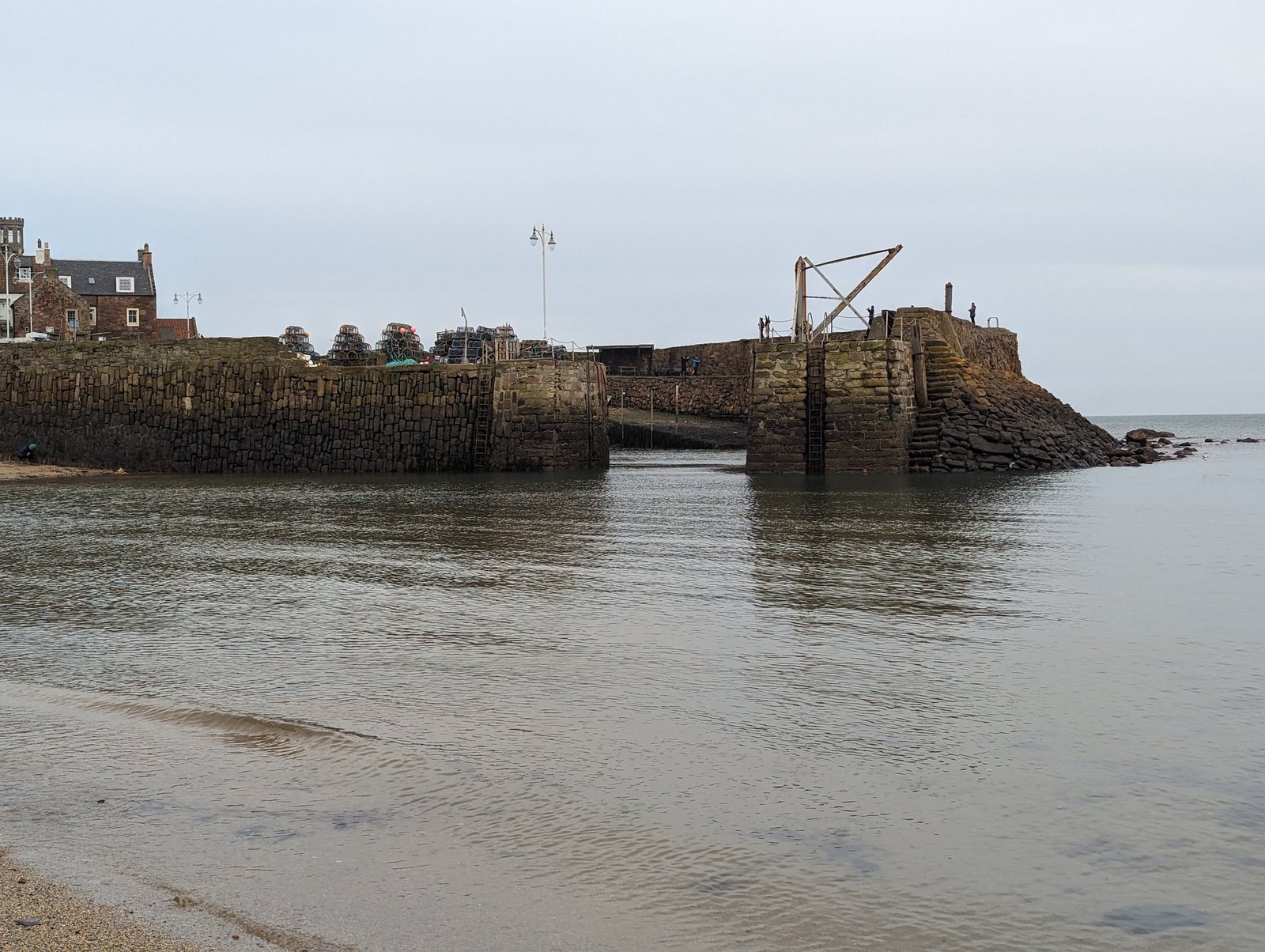 The mouth of Crail harbour and the beach at low water.