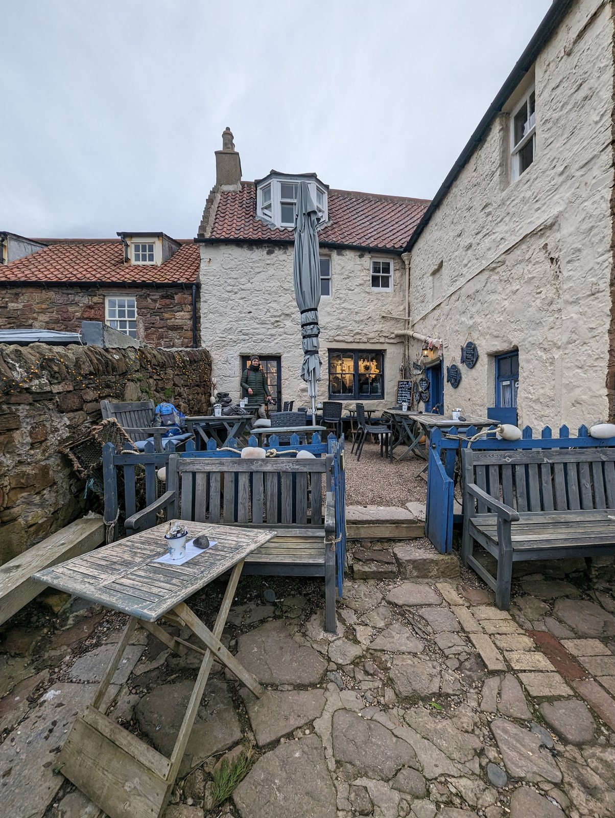 Wooden tables on the old harbour wall at Crail.