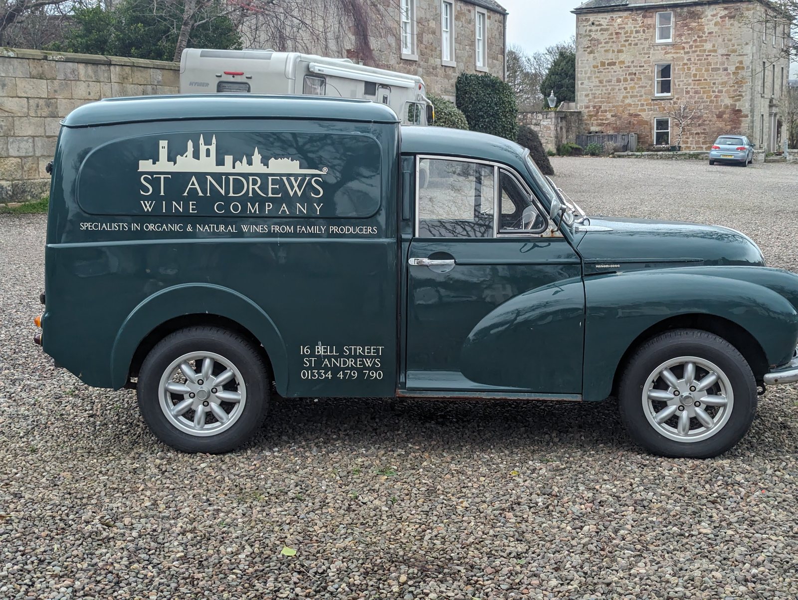 A vintage green St Andrews Wine Company Morris Minor van parked in Crail.