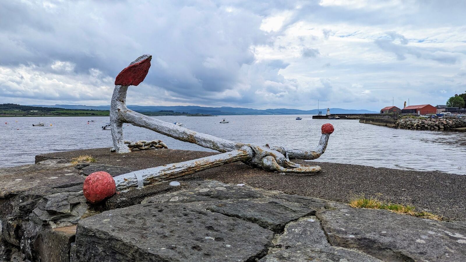 The Ardrishaig seafront on Loch Fyne with an old anchor monument on the shore.