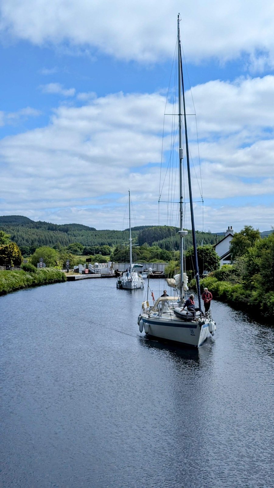 A yacht motoring along the Crinan Canal.