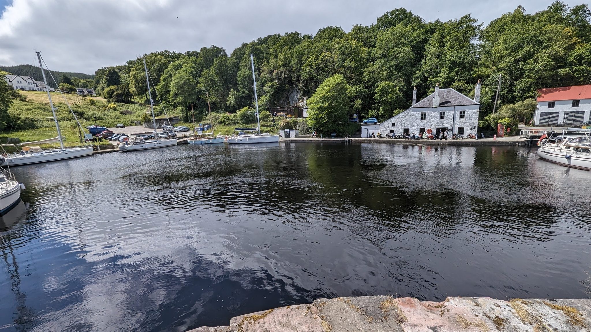 Yachts moored in the tree-fringed basin at Crinan at the western end of the canal.