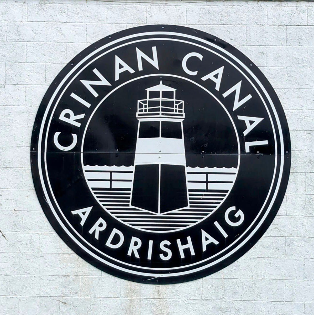 The black-and-white Crinan Canal roundel logo, with a lighthouse motif, reading 'Crinan Canal — Ardrishaig'.