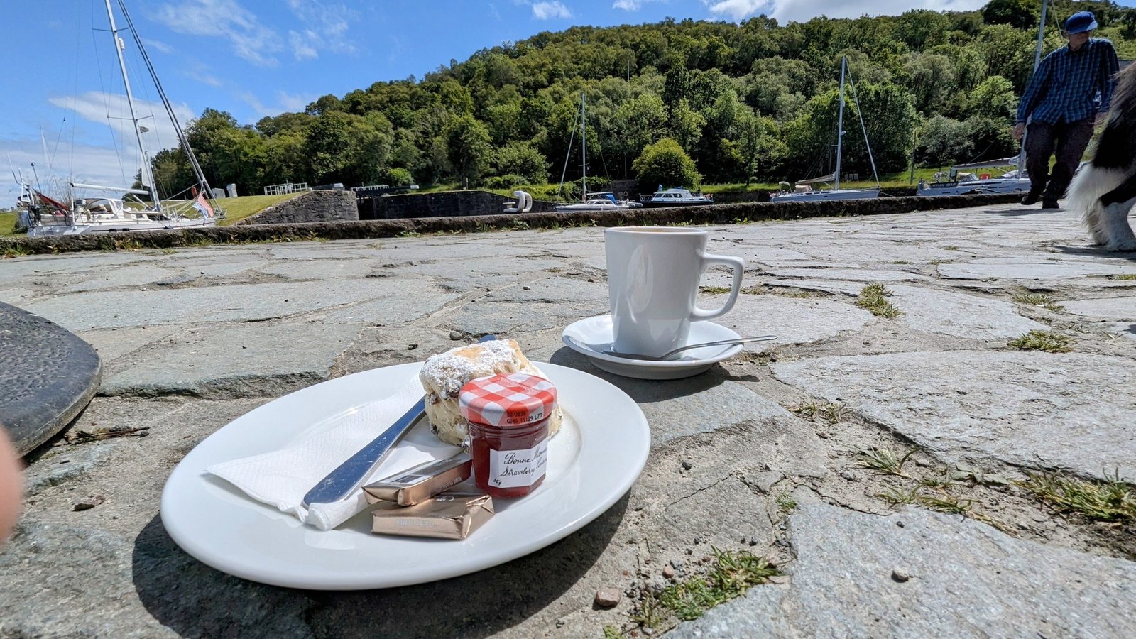 A plate of cake and a cup of coffee on a rock table above the Crinan basin.