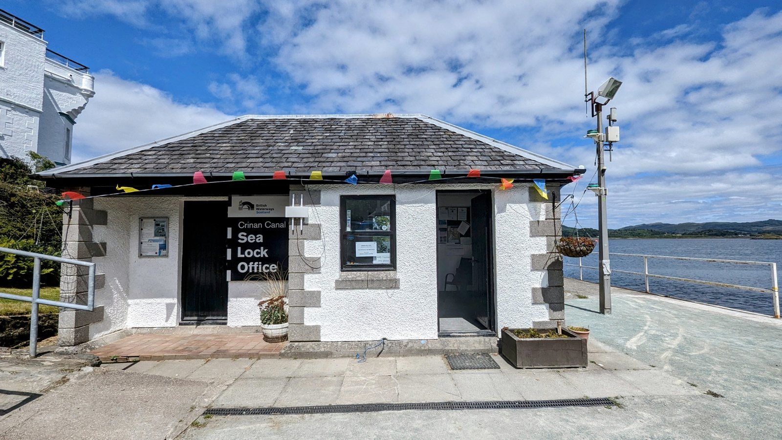 The little white Sea Lock Office building beside the Crinan sea lock.