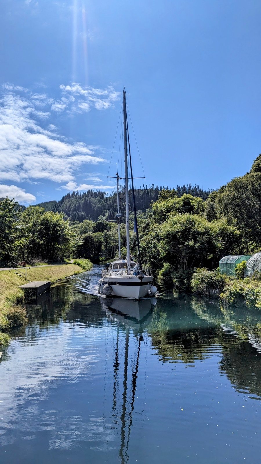 A yacht on Loch Crinan below the hills.