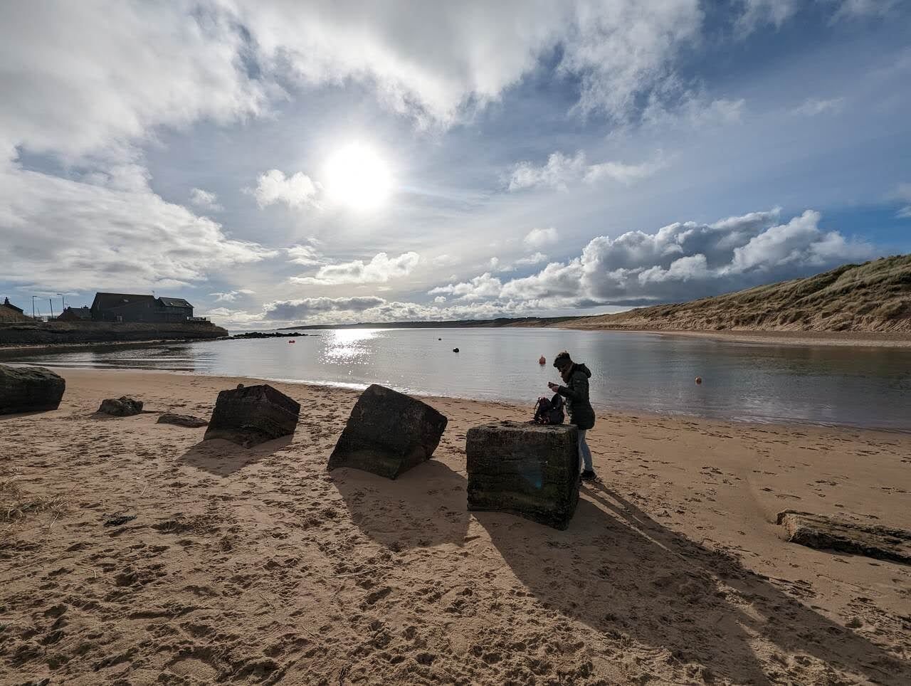 The wide sandy sweep of Cruden Bay beach at low tide.
