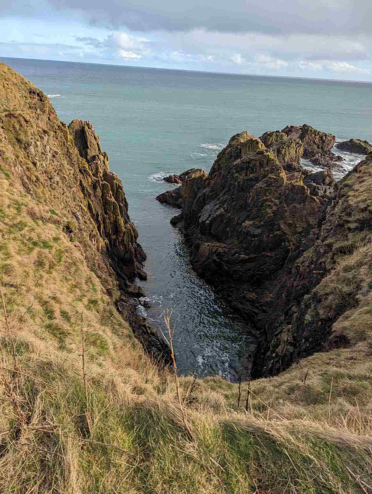 A rocky cove below the cliffs on the Cruden Bay coast.