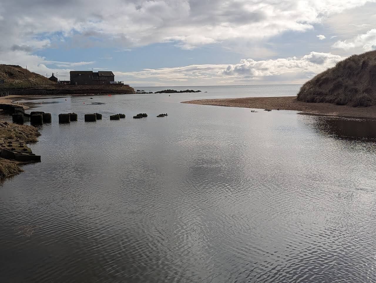 Stepping stones across the Water of Cruden where it meets the beach.
