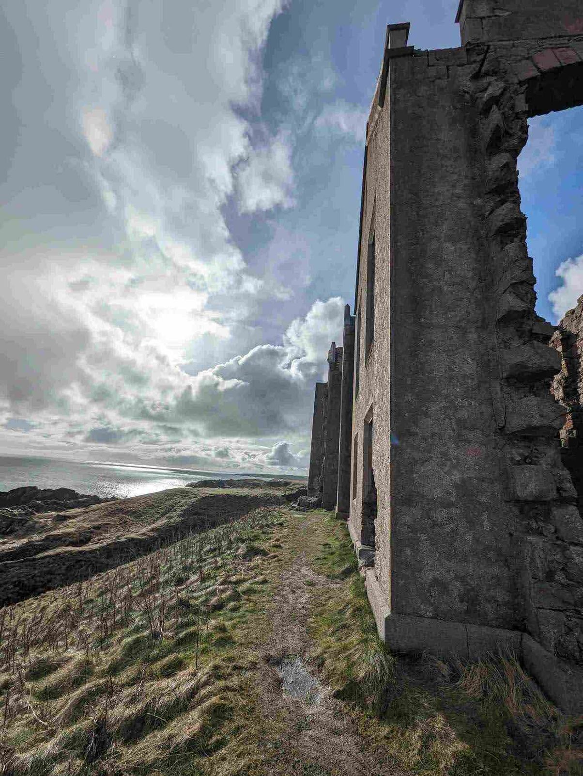 A ruined window of Slains Castle framing the sea at Cruden Bay.