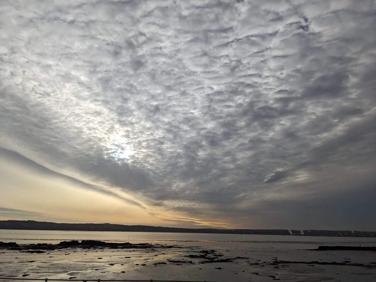 A moody, cloud-filled sky over the Firth of Forth at Culross at dusk.