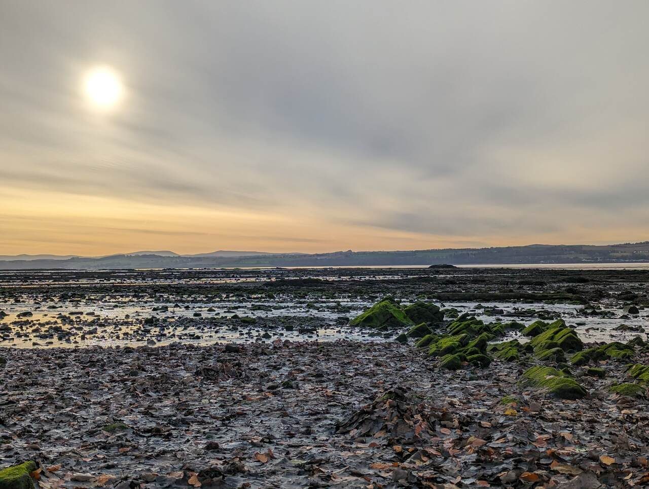 Sunset over the mudflats and rocks of the Firth of Forth foreshore at Culross.