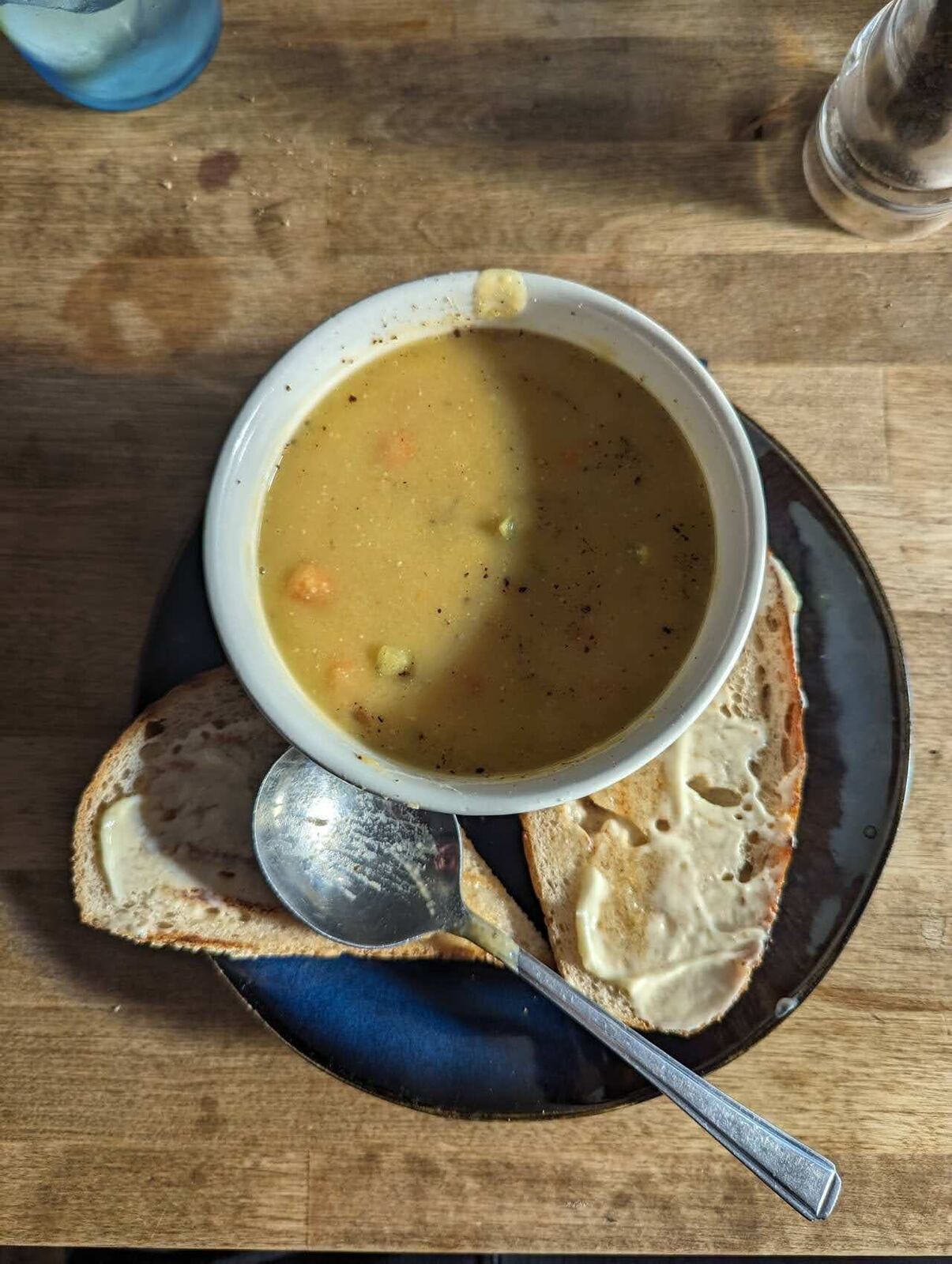 A bowl of soup and bread on a café table in Dollar.