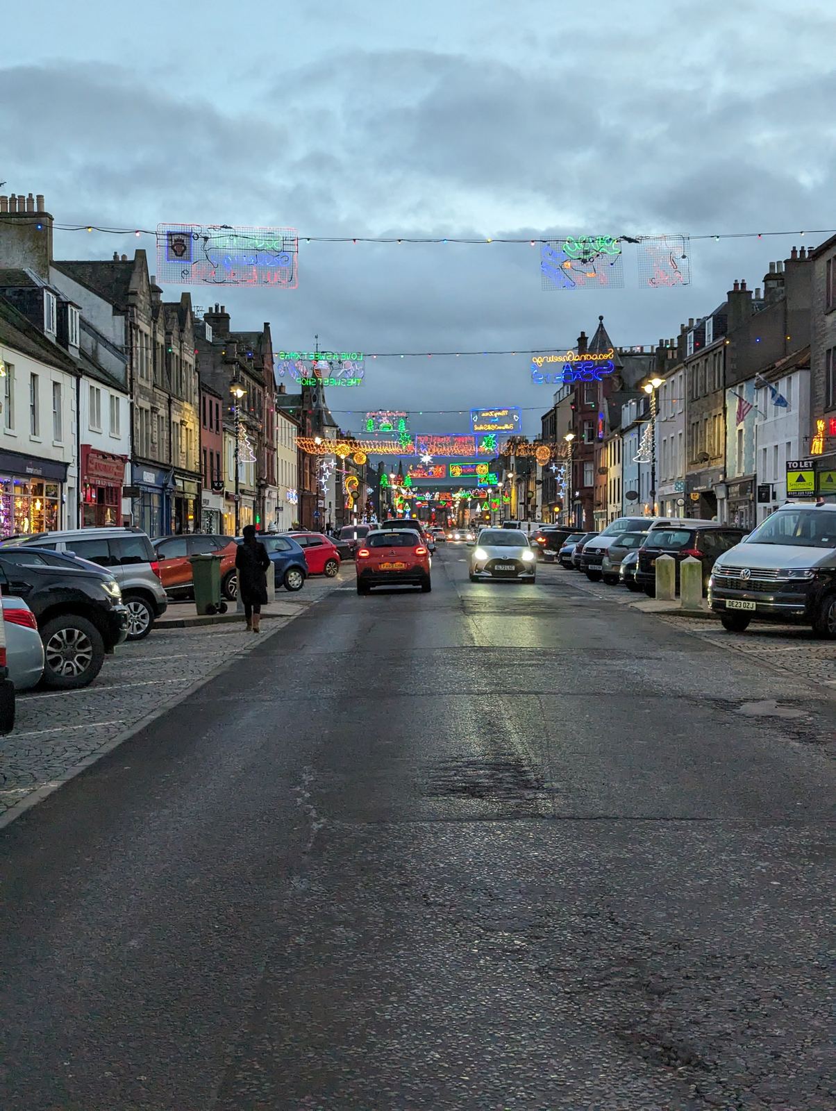 Dunbar High Street lit with Christmas lights in December.