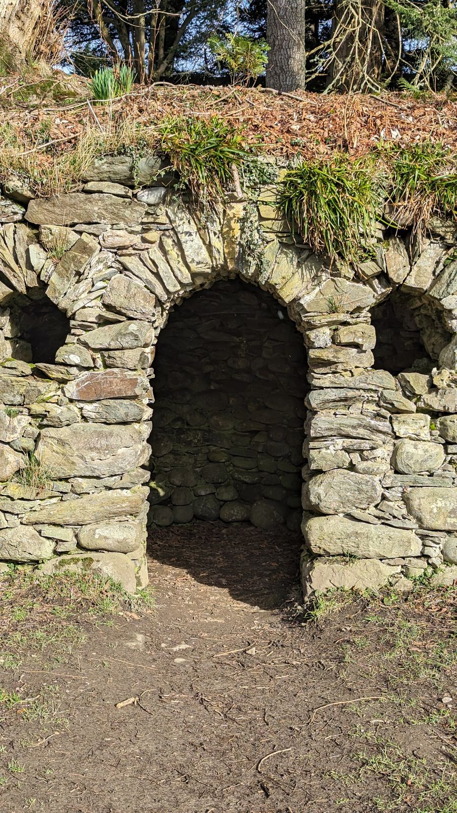 A weathered stone arch in the ruined nave of Dunkeld Cathedral.