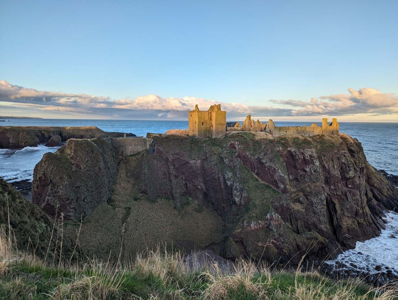 Dunnottar Castle on its headland seen from the coast path.