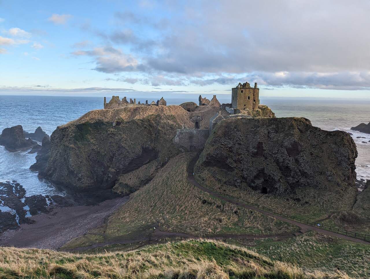 The full sweep of Dunnottar Castle across its clifftop headland.