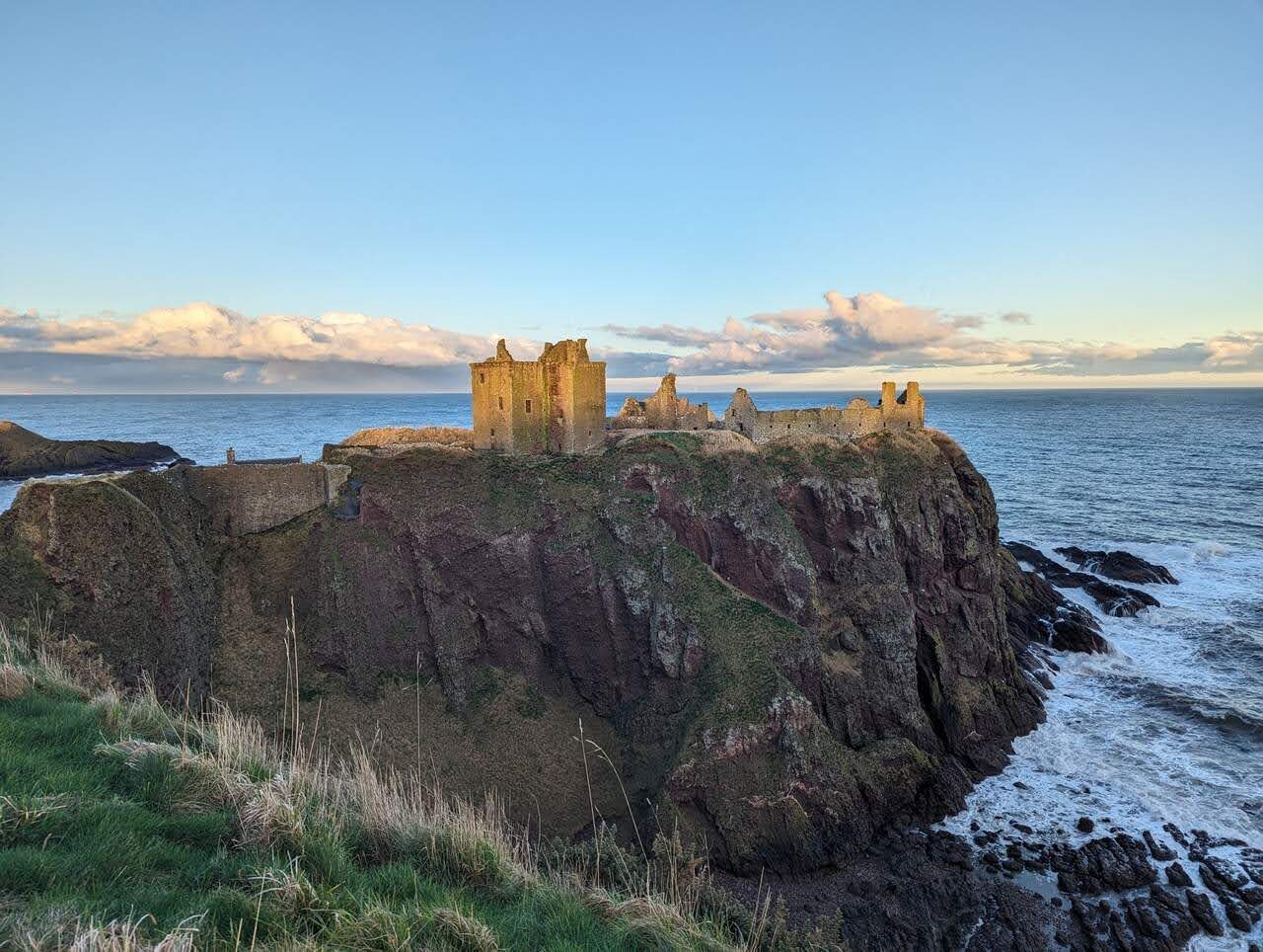 Dunnottar Castle with snow-dusted hills far inland.