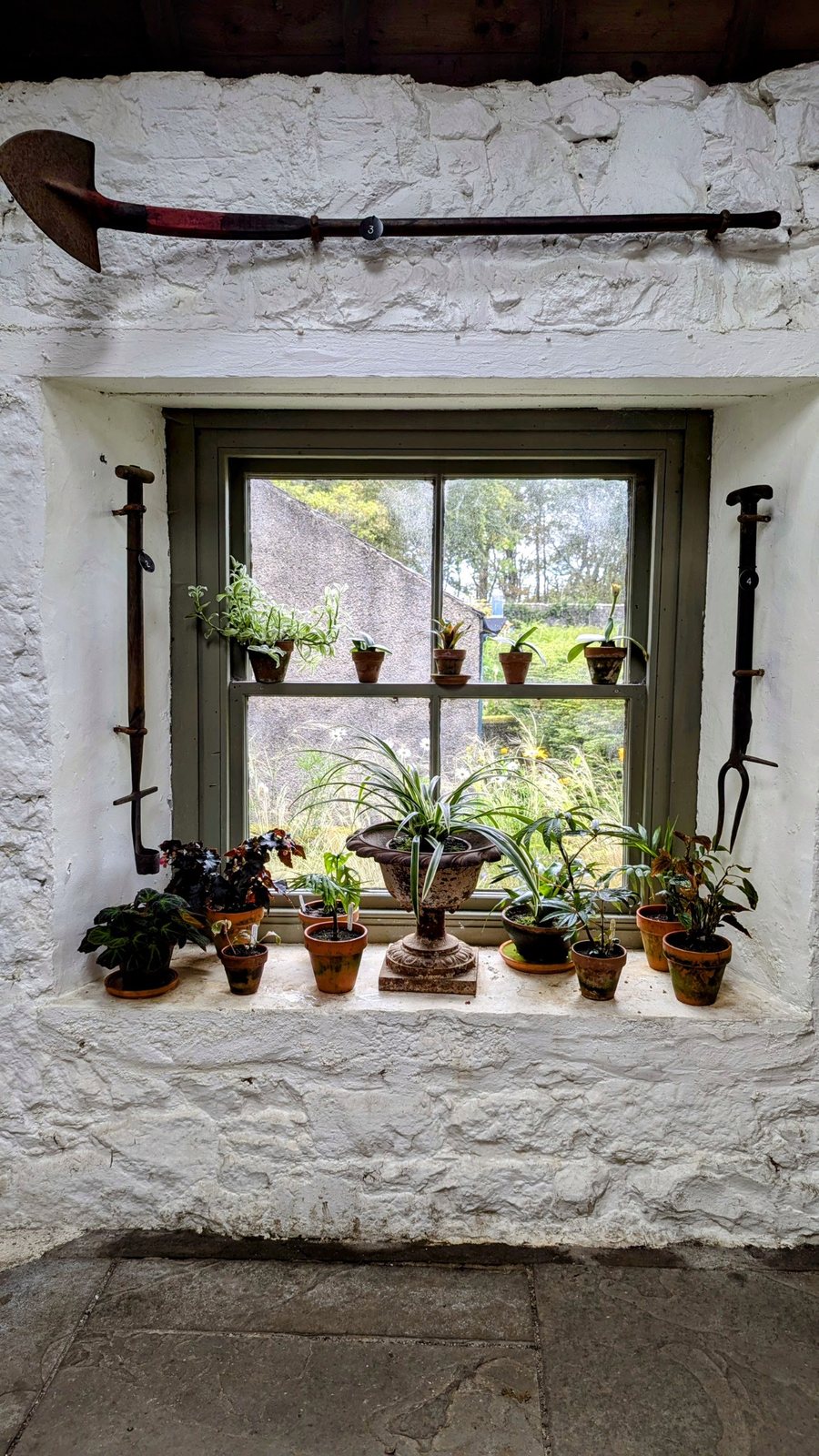 A garden gateway and greenhouse at Dunvegan Castle.