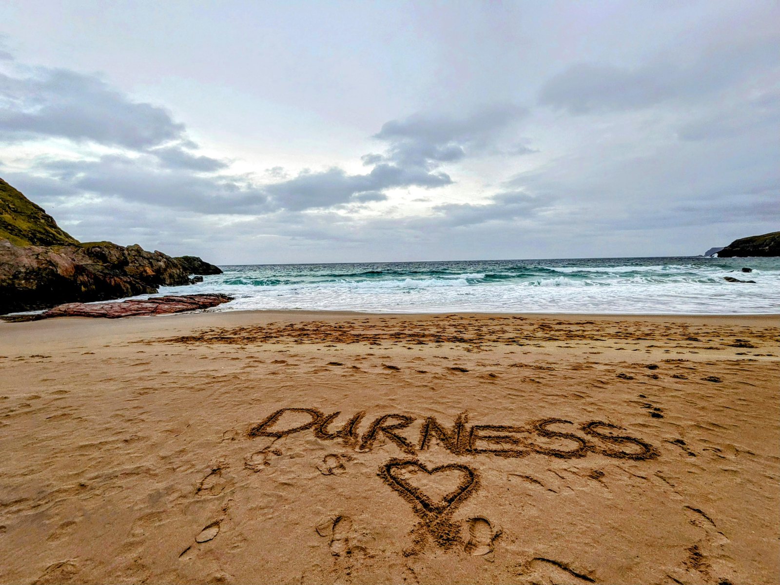 DURNESS written in the sand with a heart.