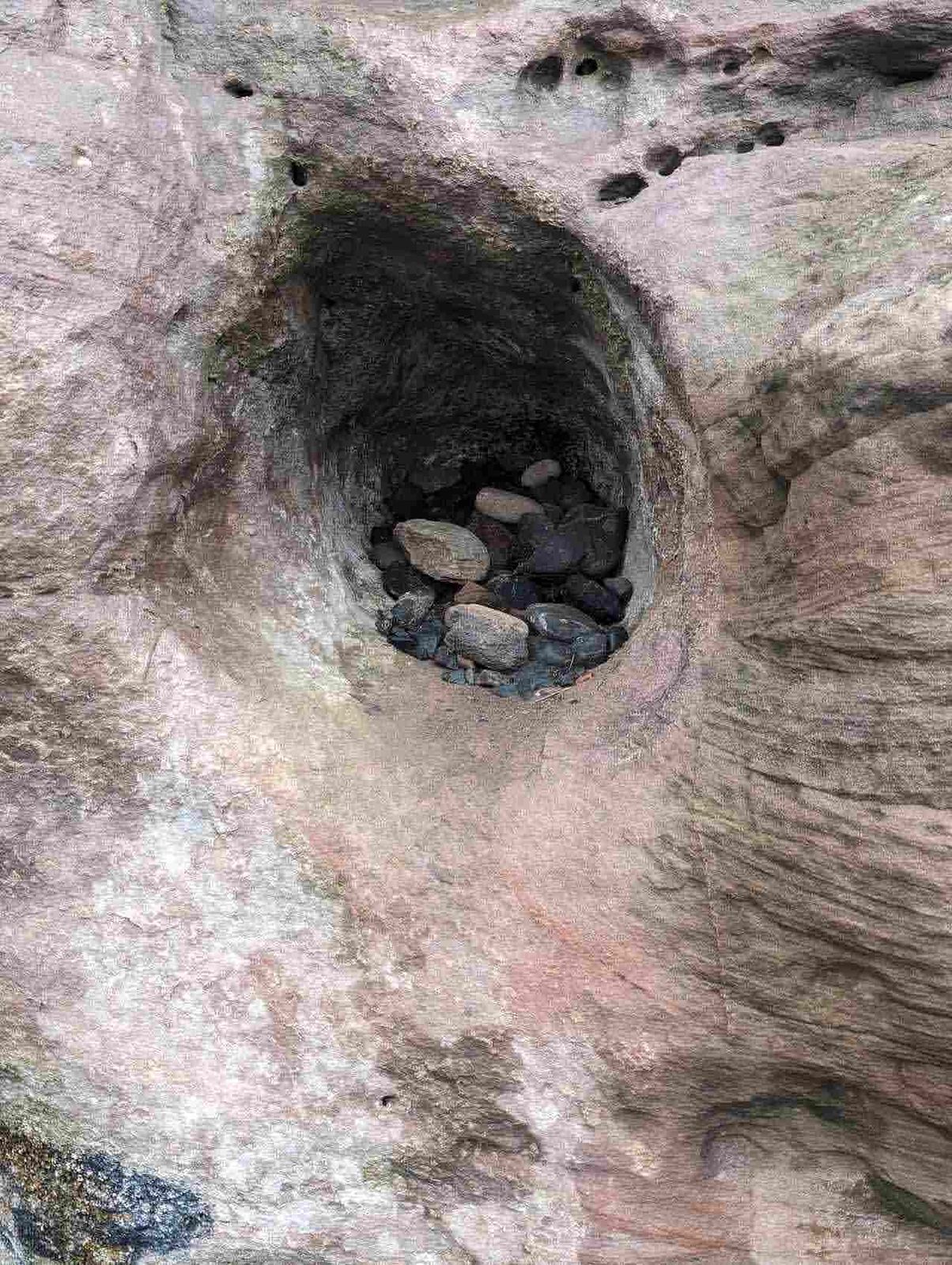 Worn hollows in the soft red sandstone at the Wemyss Caves.