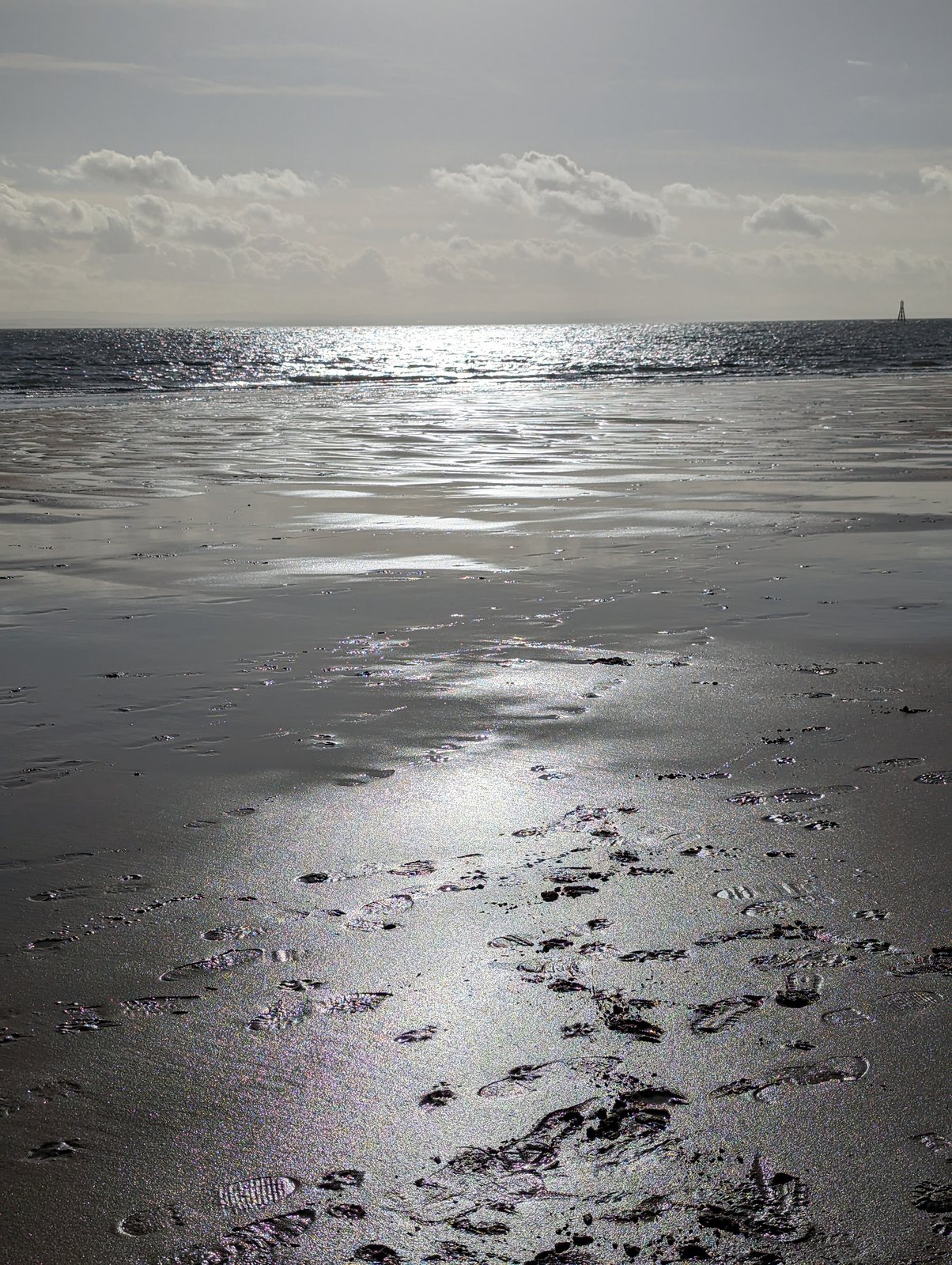 Low-tide reflections on the wet sand at Elie.