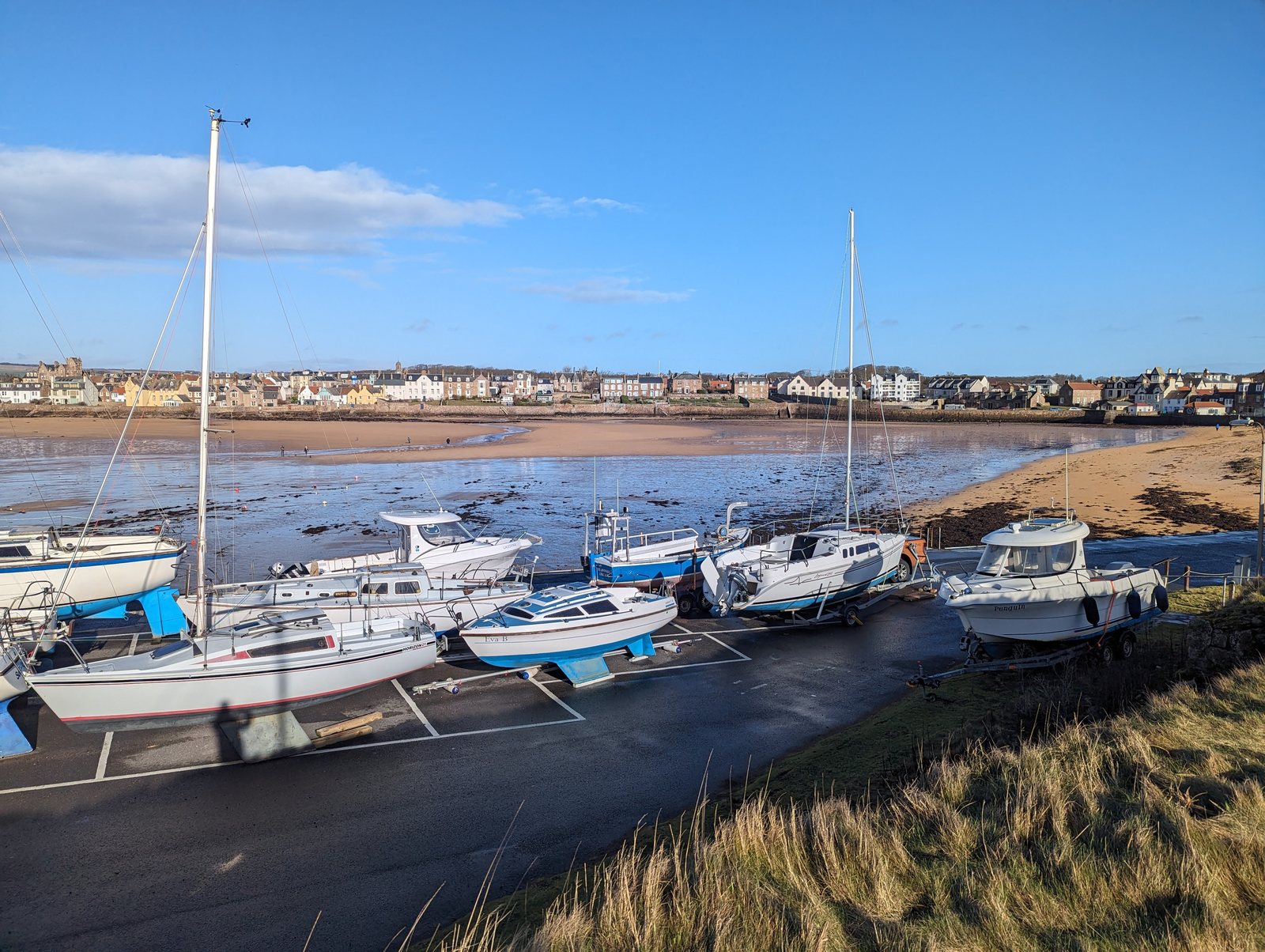 Sailing boats in Elie harbour at low tide.