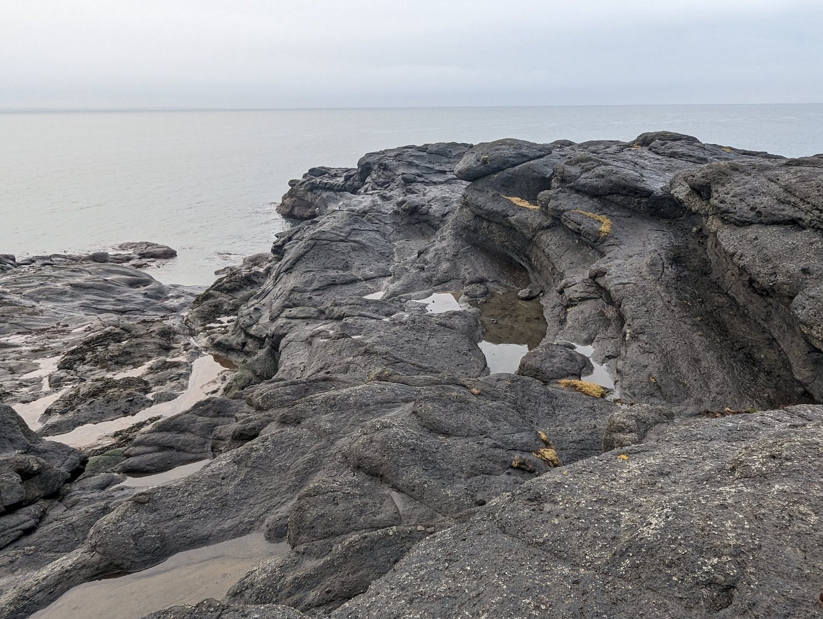 A rock arch in the volcanic rock at Elie Ness.