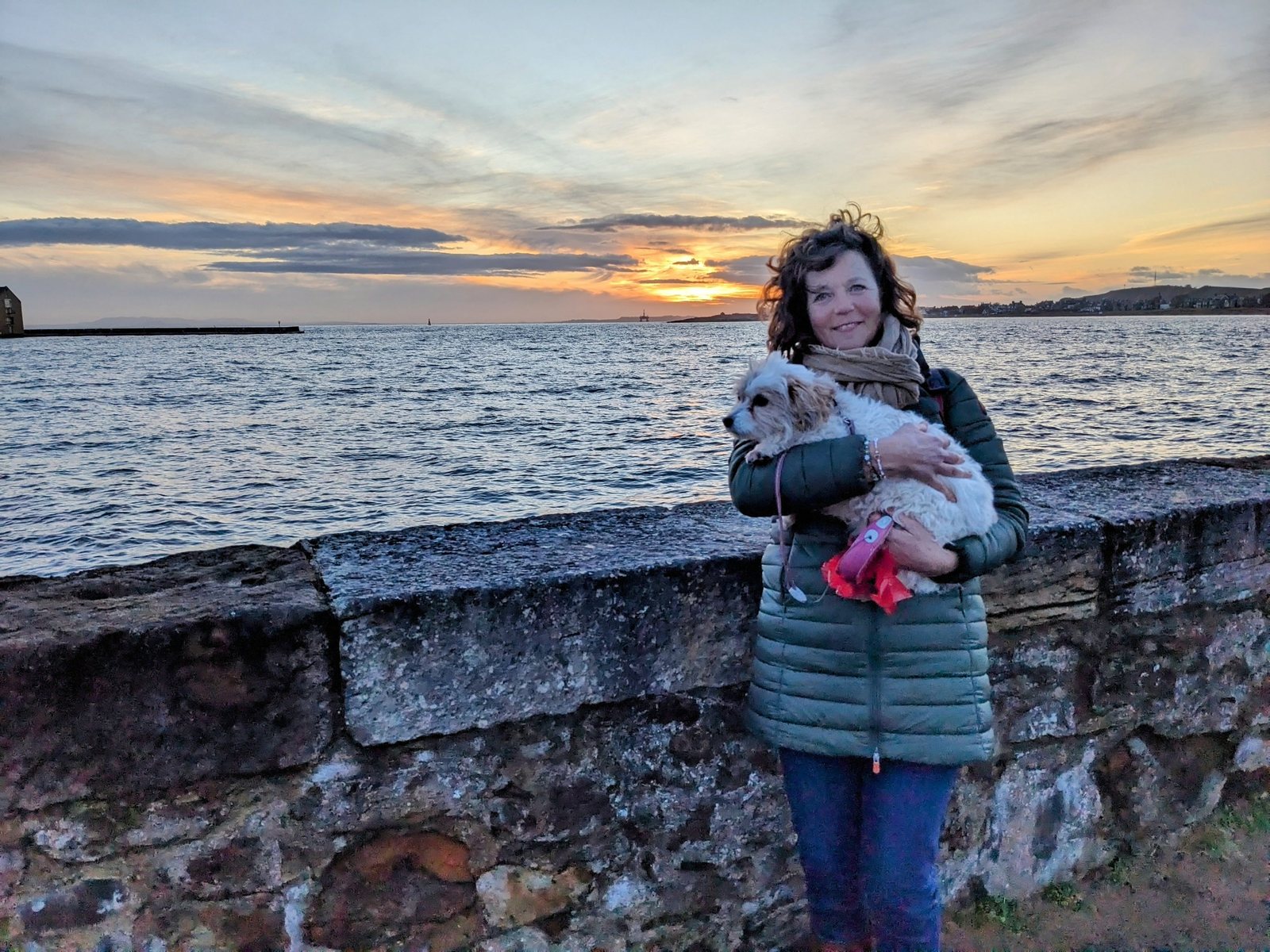 Holding Lillie by the sea wall at sunset, Elie.