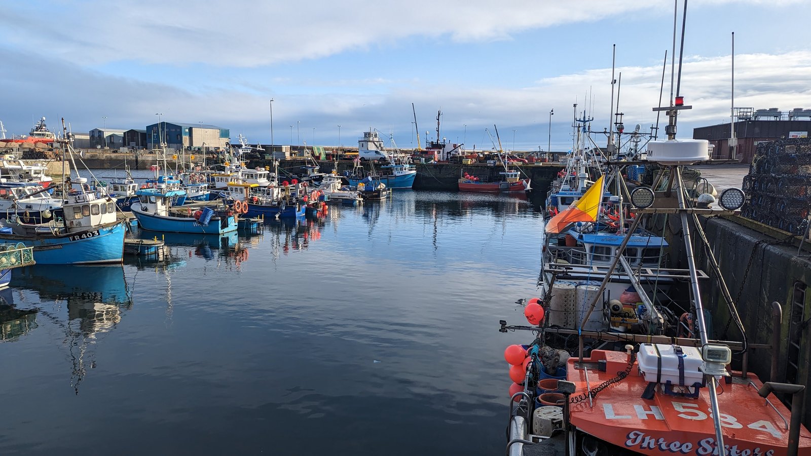 Fishing boats and a lifeboat moored in Fraserburgh harbour, Aberdeenshire.