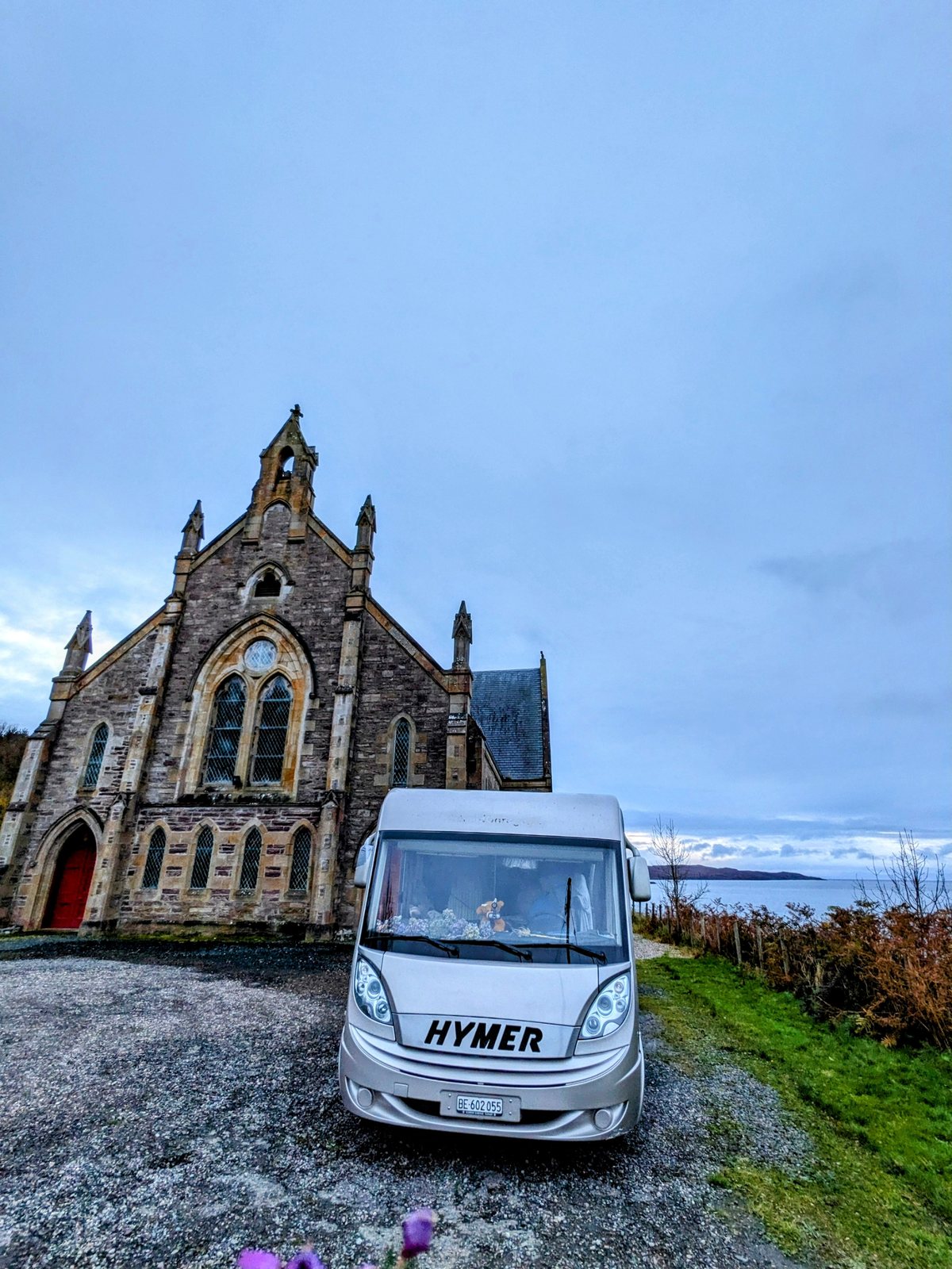 A church at Gairloch with the motorhome parked nearby.