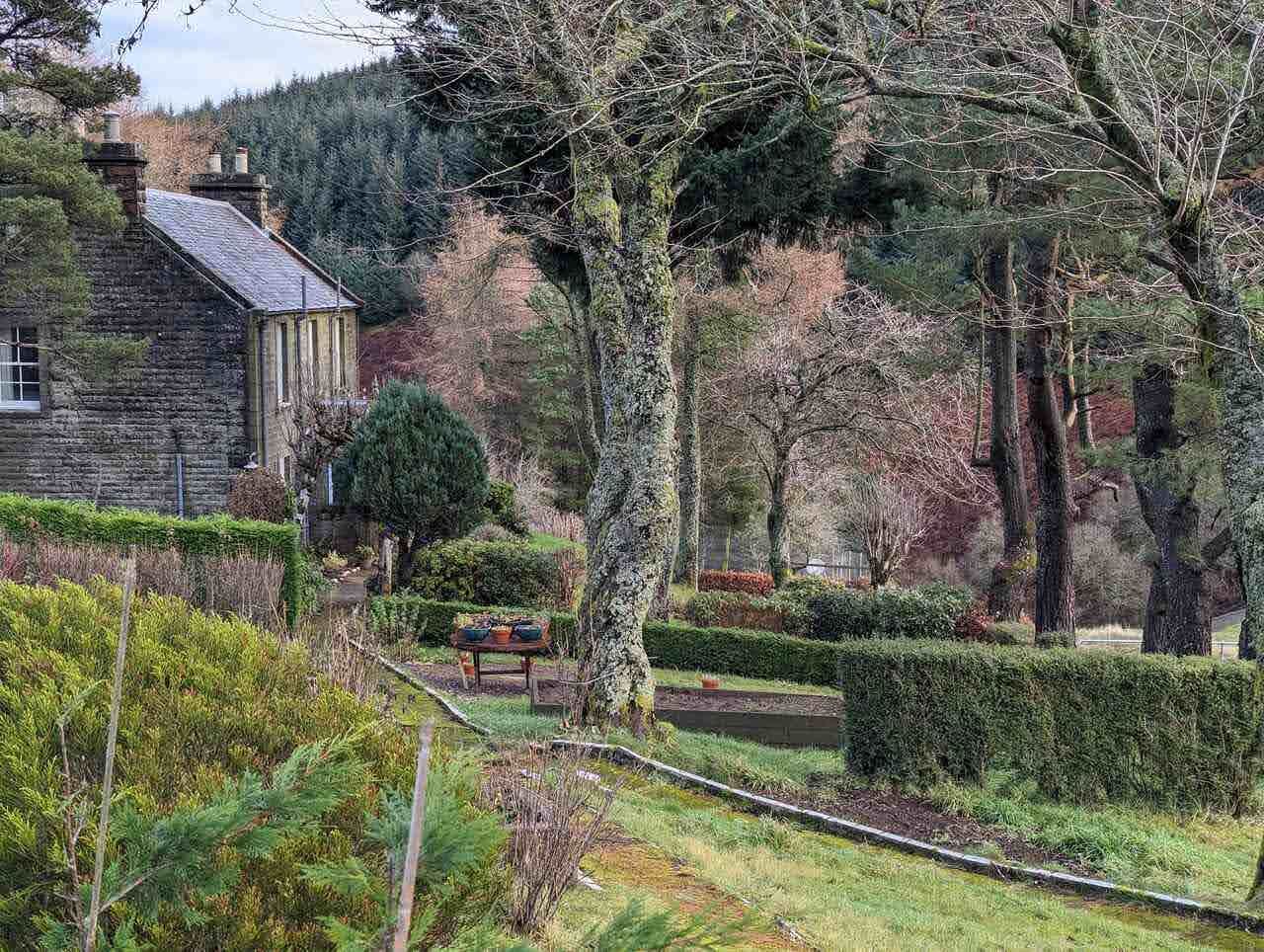 A cottage and garden in Glendevon village in winter.