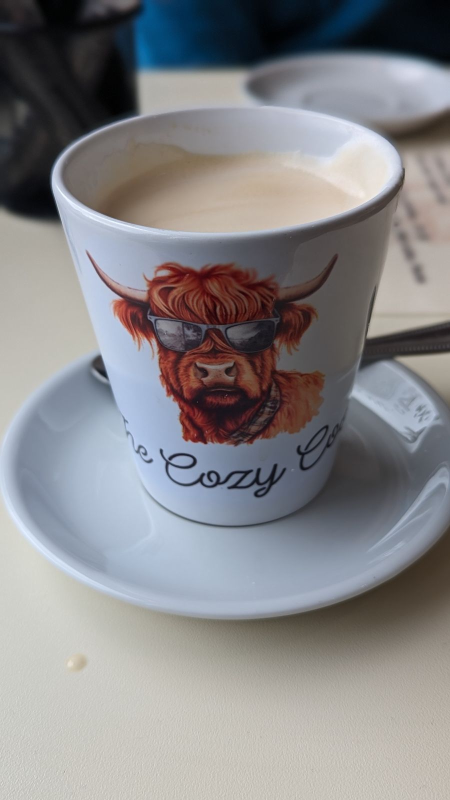 A coffee with Highland cow latte art at the Glenfiddich cafe.