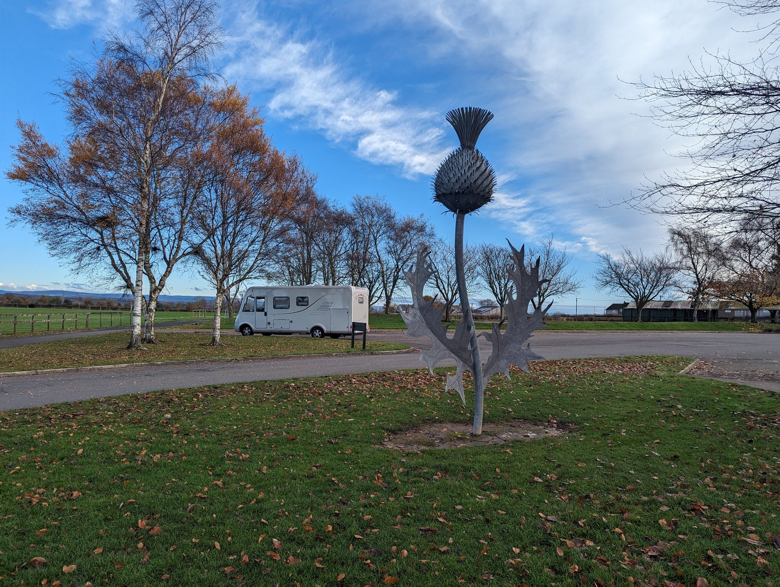 The grounds at Gretna Green with a sculpture and parkland.
